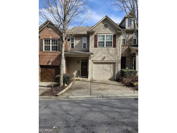 Charming townhouse with attached garage, neat landscaping, and a cozy front entrance at 2764 Keystone Ave, Lithonia, GA 30058