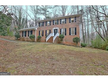 Classic brick home with a symmetrical design, white stairs, and mature landscaping at 200 Deer Forest Trl, Fayetteville, GA 30214