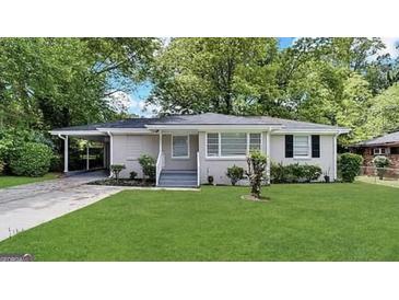 Charming single-story home with a well-manicured lawn and a convenient carport at 3011 Belvedere Ln, Decatur, GA 30032