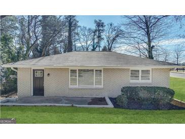 Charming single-story brick home featuring a landscaped front yard and a welcoming front door at 105 Hillside Se Ave, Atlanta, GA 30315