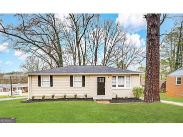 Charming single-story home featuring a well-manicured lawn, complemented by freshly laid mulch at 360 Belgarde Pl, Atlanta, GA 30354