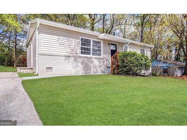 Charming home featuring a lush green lawn and a welcoming front entrance at 312 Fairburn Nw Rd, Atlanta, GA 30331