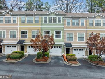 Charming townhomes with colorful exteriors, manicured landscaping, and attached garages offer modern living in a vibrant community at 1933 Sterling Oaks Ne Cir, Atlanta, GA 30319