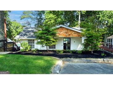 Charming single-story home featuring lush landscaping, black mulch and an inviting entrance at 6337 Lakeview Dr, Buford, GA 30518