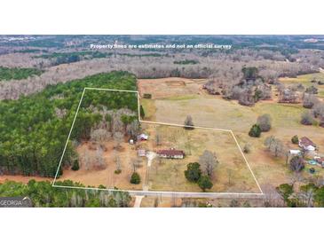 Expansive aerial view of property featuring charming home, large workshop, open land, and partial tree coverage at 62 Honey Ln, Mcdonough, GA 30252