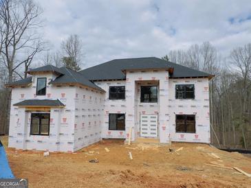 Under construction two-story home featuring a modern design with multiple windows at 2015 Fontainbleau Dr, Conyers, GA 30094