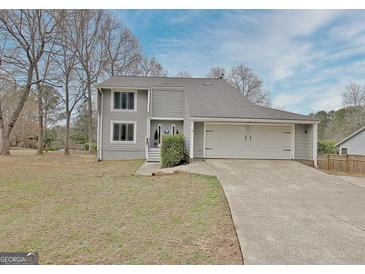 Charming two-story home with a gray exterior, two-car garage, and a well-maintained lawn at 101 Nightwind Ct, Peachtree City, GA 30269