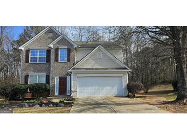 Charming two-story home featuring a two-car garage and a well-maintained front yard at 801 Winbrook Dr, Mcdonough, GA 30253