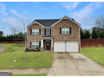 Charming two-story brick home with a well-manicured lawn and attached two-car garage at 3092 Cedar Crest Way, Decatur, GA 30034