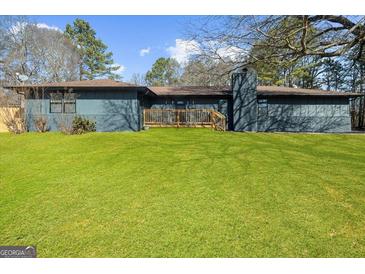 Charming single-story home with a brick chimney, well-maintained lawn, and inviting front porch at 2692 Fairview Rd, Covington, GA 30016