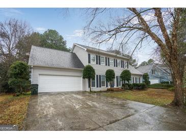 Traditional two-story home with a large two-car garage, a grey roof, and black shutters at 3973 Laurel Bend Dr, Snellville, GA 30039
