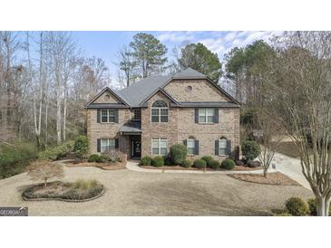 Charming two-story brick home with a well-manicured front yard and welcoming entrance at 1110 Eagles Brooke Dr, Locust Grove, GA 30248