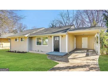 Charming ranch-style home with a covered carport, well-maintained lawn, and inviting front entrance at 2310 Ousley Ct, Decatur, GA 30032