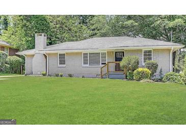 Charming ranch-style home featuring a well-manicured lawn and a classic brick exterior at 2030 Mark Trl, Decatur, GA 30032