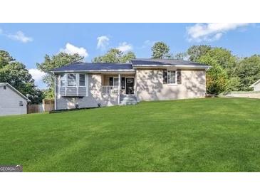 Charming home featuring a well-manicured lawn, classic neutral paint, and a welcoming front entrance at 246 Bridgewood Se Dr, Conyers, GA 30094