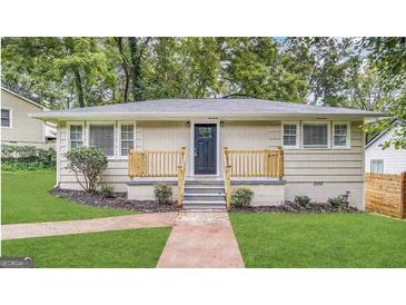 Charming home featuring a well-maintained front yard, stone walkway and inviting front porch at 2922 Dale Pl, Decatur, GA 30032