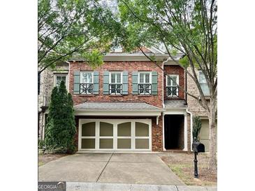 Charming two-story brick home with a two-car garage and lovely, light-blue shutters at 44 Star Spangled Ln, Peachtree City, GA 30269