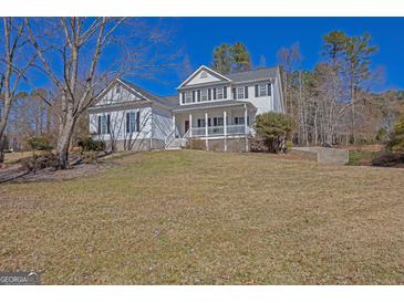Charming two-story home featuring a welcoming front porch and traditional architectural details at 245 Longshore Way, Fayetteville, GA 30215