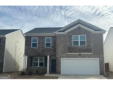 Charming two-story home features a mix of brick and stone exterior at 1879 Redfern Rd, Dacula, GA 30019