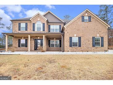 Charming two-story brick home featuring a covered front porch and well-maintained landscaping at 224 Jester Ct, Mcdonough, GA 30252