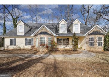 Charming single-Gathering home with stone accents and dormer windows, set amidst mature trees at 603 Honey Creek Rd, Mcdonough, GA 30252