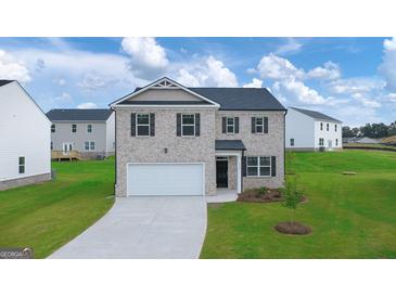 Charming two-story home with brick facade, attached garage, and well-manicured lawn at 552 Whitman Lane # 2014, Stockbridge, GA 30281