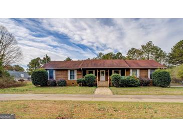 Charming single-story home featuring a well-maintained lawn and inviting front entrance at 5687 Highway 212 N, Covington, GA 30016