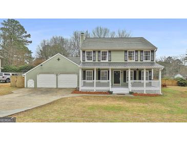 Charming two-story home with an inviting front porch and a spacious two-car garage at 100 Spincast Ct, Peachtree City, GA 30269