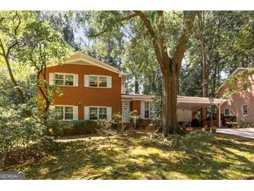 Charming two-story brick home with white shutters and mature trees at 1387 John Robert Dr, Morrow, GA 30260