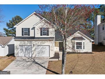 Charming two-story home with a well-maintained lawn, a two-car garage, and a classic suburban appeal at 2391 Wellborn Hills Ct, Lithonia, GA 30058