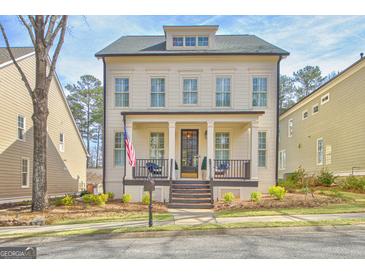 Charming two-story home with a welcoming front porch, black accents, and an American flag at 120 Middleton Dr, Peachtree City, GA 30269