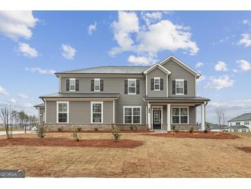 Charming two-story home with gray siding, black shutters, and landscaped front yard at 275 Arwen Dr # 68, Mcdonough, GA 30252
