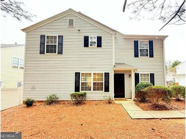 Two-story home featuring neutral siding and dark shutters, complemented by manicured landscaping at 235 Windcroft, Acworth, GA 30101