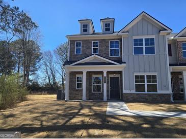 Beautiful two-story home with stone facade, dormers, and covered entrance at 4853 Walkers Green, Mableton, GA 30126