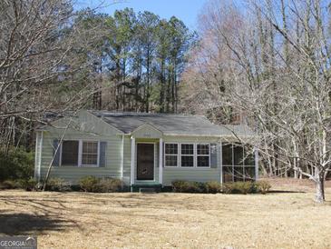 Charming single-story home with light-green siding and a well-maintained front yard, perfect for first-time buyers at 1989 Grant Sw Rd, Atlanta, GA 30331