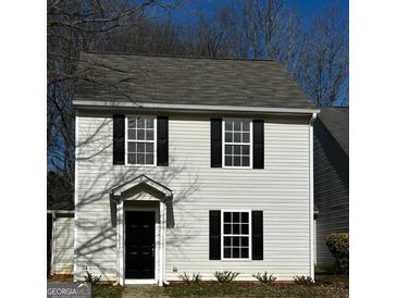 Charming two-story home features black shutters and neutral siding at 309 Coral Cir, Mcdonough, GA 30253