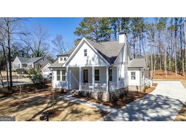 Charming white home with a covered front porch and well-manicured lawn at 5167 Martin St, Covington, GA 30014