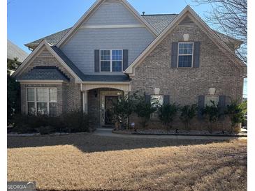Charming brick home with a symmetrical facade, a manicured lawn, and a welcoming entryway at 1186 Diamond Xing, Mcdonough, GA 30252
