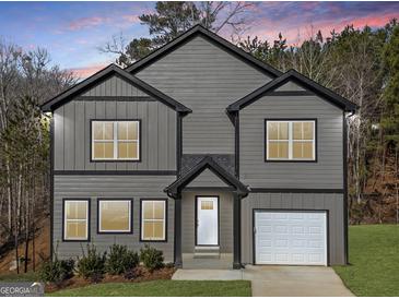 Charming two-story home with gray siding, black trim, a front-entry garage, and a well-manicured lawn at 3195 Tackett Rd, Douglasville, GA 30135