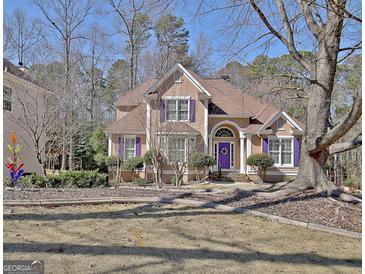 Charming two-story home with a manicured lawn and purple shutters adding a pop of color at 123 Fielding Rdg, Peachtree City, GA 30269