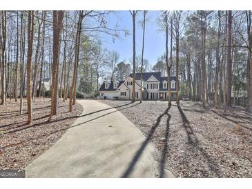 Traditional two story home featuring a long driveway surrounded by mature trees at 114 Oak Ridge Dr, Sharpsburg, GA 30277