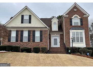 Charming two-story brick home with black shutters and well-manicured landscaping at 3223 Thornecreek Dr, Douglasville, GA 30135