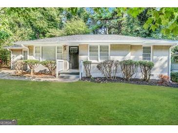 Charming single-story home with a lush green lawn and mature trees at 2804 Mitchell Dr, Decatur, GA 30032