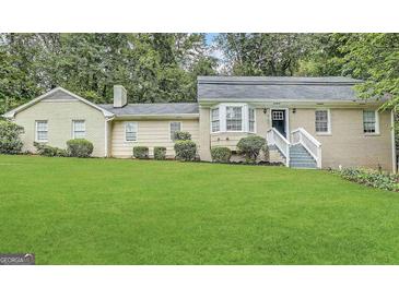 Charming home with a lush green lawn and well-maintained landscaping at 2430 Fern Valley Ct, East Point, GA 30344