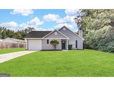 Charming one-story home with a well-manicured lawn, attached garage, and classic architectural details at 890 Old Rocky Rd, Atlanta, GA 30349