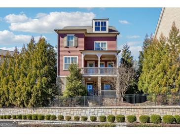 Charming two-story home with covered balconies, stone accents, and professionally landscaped front yard at 1685 Tabor Dr, Marietta, GA 30062
