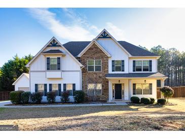 Charming two-story home featuring stone accents, white siding, and lush landscaping at 45 George Wynn Rd, Palmetto, GA 30268