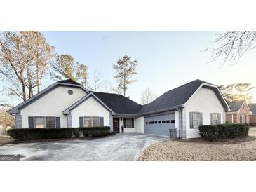 Charming single-story home featuring a two-car garage and beautifully landscaped front yard at 2768 Southpark Sw Blvd, Conyers, GA 30094