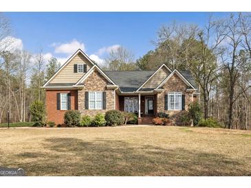 Charming brick and stone home with well-maintained landscaping and a welcoming front entrance at 172 Sam Solomon Rd, Locust Grove, GA 30248