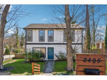 Charming two-story home with a welcoming blue door and fresh green lawn at 2405 Hillside Ave, Decatur, GA 30032